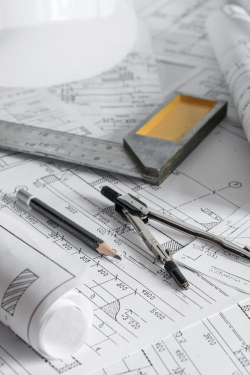 architect design working drawing sketch plans blueprints and making architectural construction model